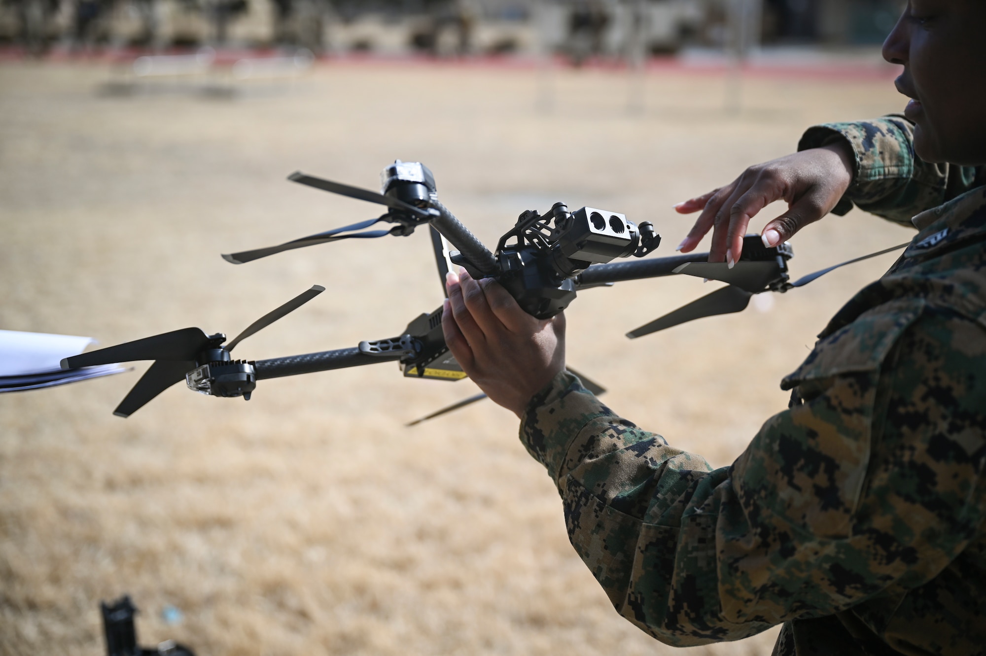 U.S. Marine Corps Sgt. Cyan Williams, an electrician with Marine Wing Support Squadron 172, Marine Aircraft Group 36, 1st Marine Aircraft Wing, inspects a small unmanned aircraft system.