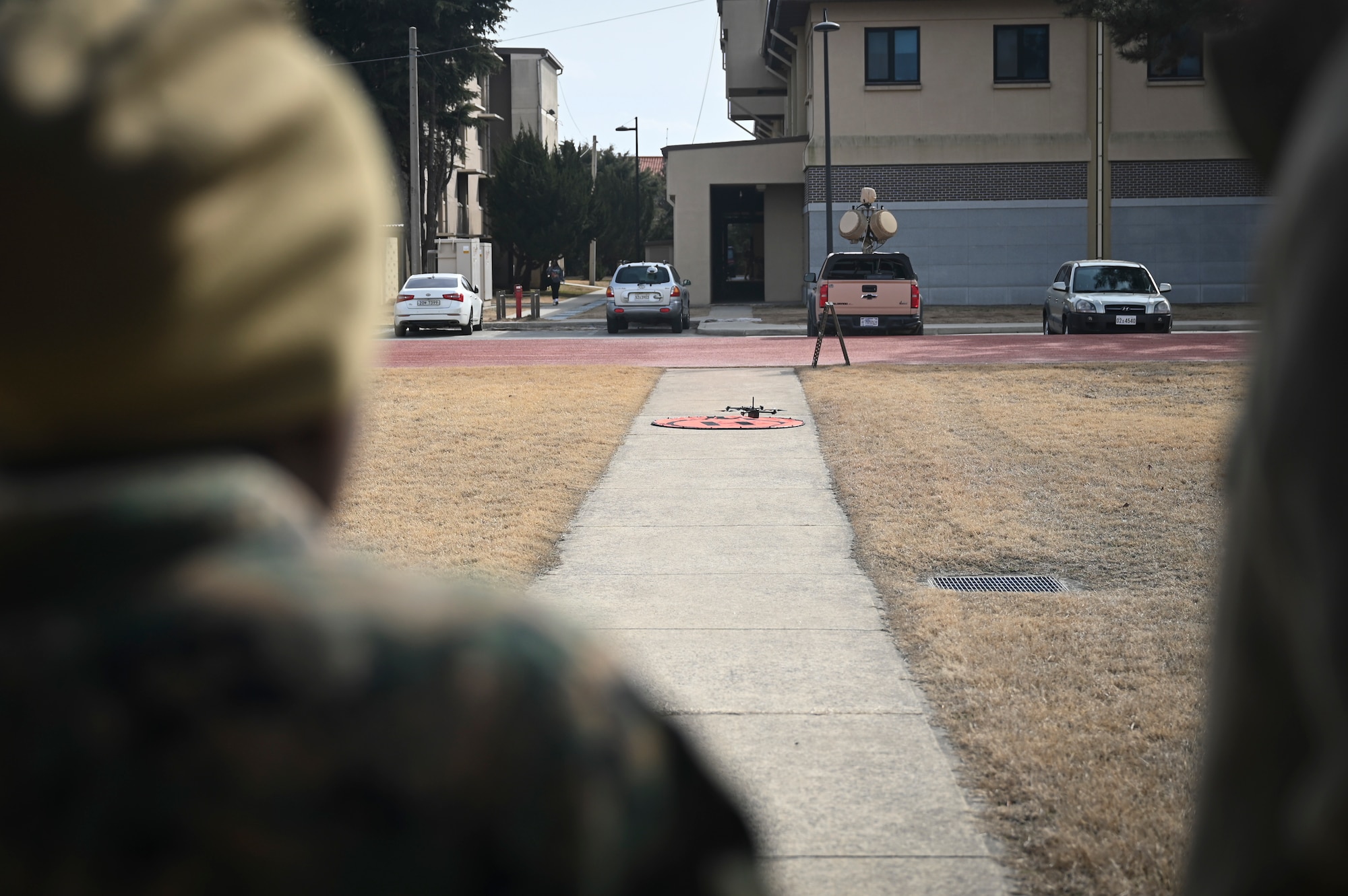 U.S. Marine Corps Sgt. Cyan Williams, an electrician with Marine Wing Support Squadron 172, Marine Aircraft Group 36, 1st Marine Aircraft Wing, lands a small unmanned aircraft system.