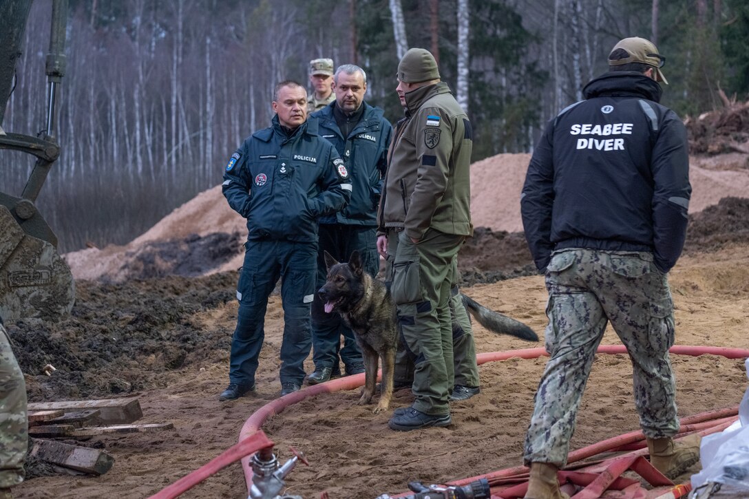 Maik, a search and rescue military police dog and his handler of the Estonian Defense Force assist in recovery efforts of a missing U.S. soldier on a military training site