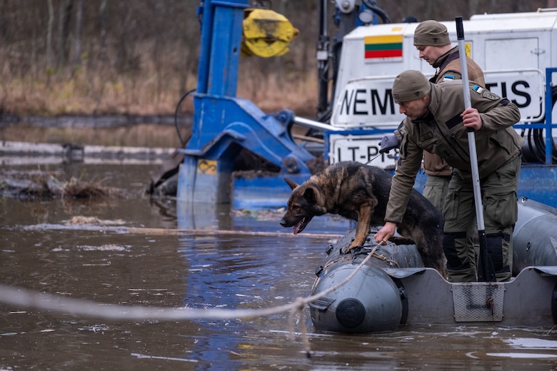 Maik, a search and rescue military police dog and his handler of the Estonian Defense Force assist in recovery efforts of a missing U.S. soldier on a military training site