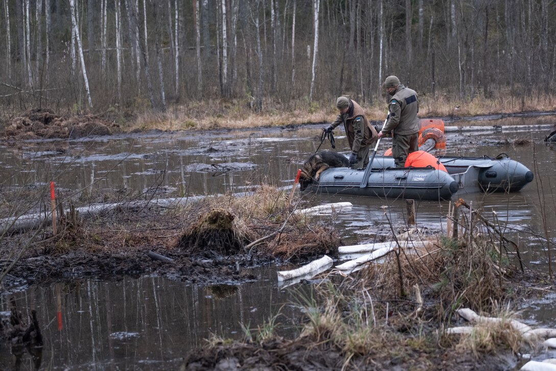 Maik, a search and rescue military police dog and his handler of the Estonian Defense Force assist in recovery efforts of a missing U.S. soldier on a military training site