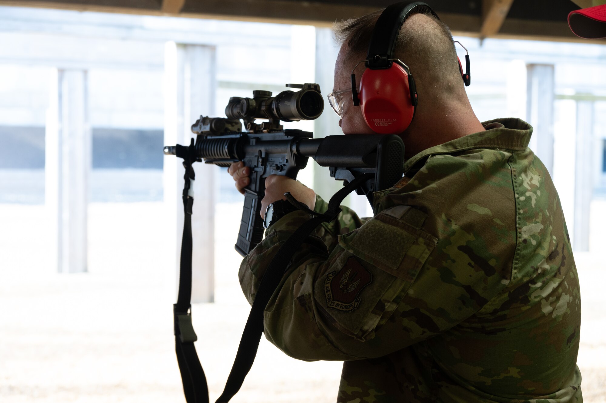 U.S. Air Force Col. D. Landon Phillips, 501st Combat Support Wing commander, fires an M4 rifle