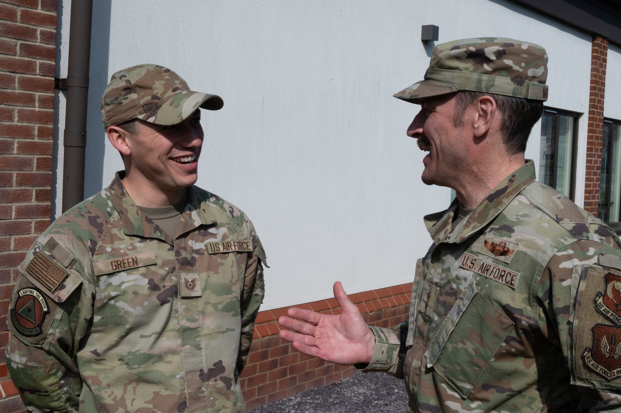 U.S. Air Force Maj. Gen. Paul Moga, Third Air Force commander, speaks with Technical Sgt. Jesse Green
