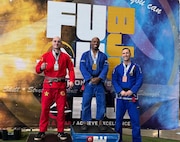 Maj. Chris Wright, center, stands on the podium after winning his division at a Brazilian Jiu-Jitsu tournament in Hagerstown, Maryland. Wright, an operations officer with U.S. Army Medical Logistics Command, was promoted to black belt in the ground-fighting style martial art in December 2024.