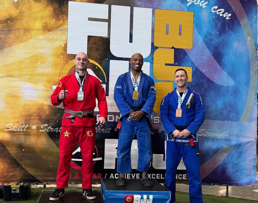 Maj. Chris Wright, center, stands on the podium after winning his division at a Brazilian Jiu-Jitsu tournament in Hagerstown, Maryland. Wright, an operations officer with U.S. Army Medical Logistics Command, was promoted to black belt in the ground-fighting style martial art in December 2024.