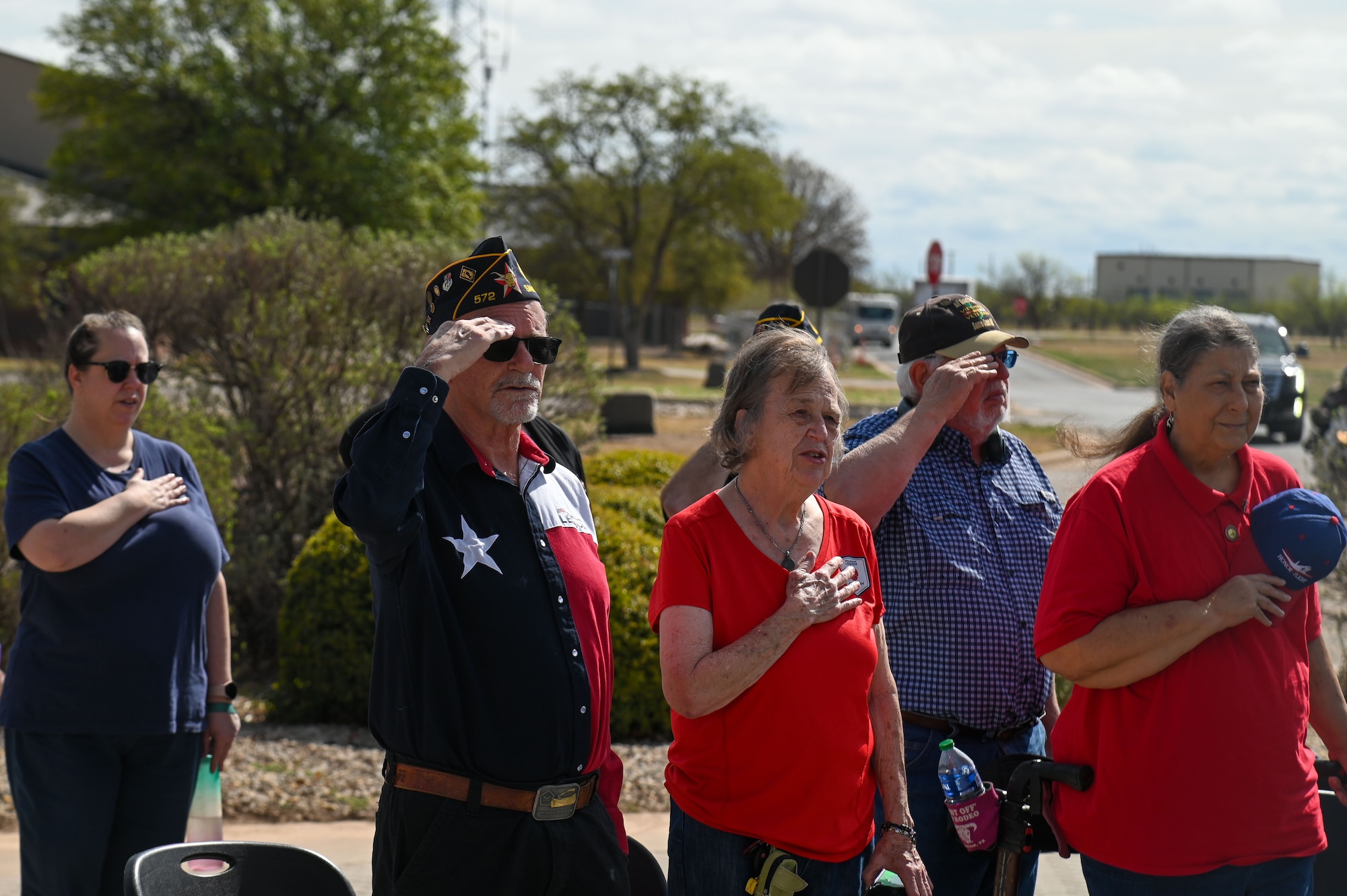 Veterans alongside their families and San Angelo community members display proper customs and courtesies while the national anthem plays at the National Vietnam War Veterans Day Commemoration Ceremony at the Weyandt-Eddy Memorial Plaza, outside the Norma Brown Headquarters building, Goodfellow Air Force Base, Texas, March 28, 2025. This year’s observance marks the 52nd anniversary of the withdrawal of U.S. combat troops from Vietnam on March 29, 1973. (U.S. Air Force photo by Airman 1st Class James Salellas)