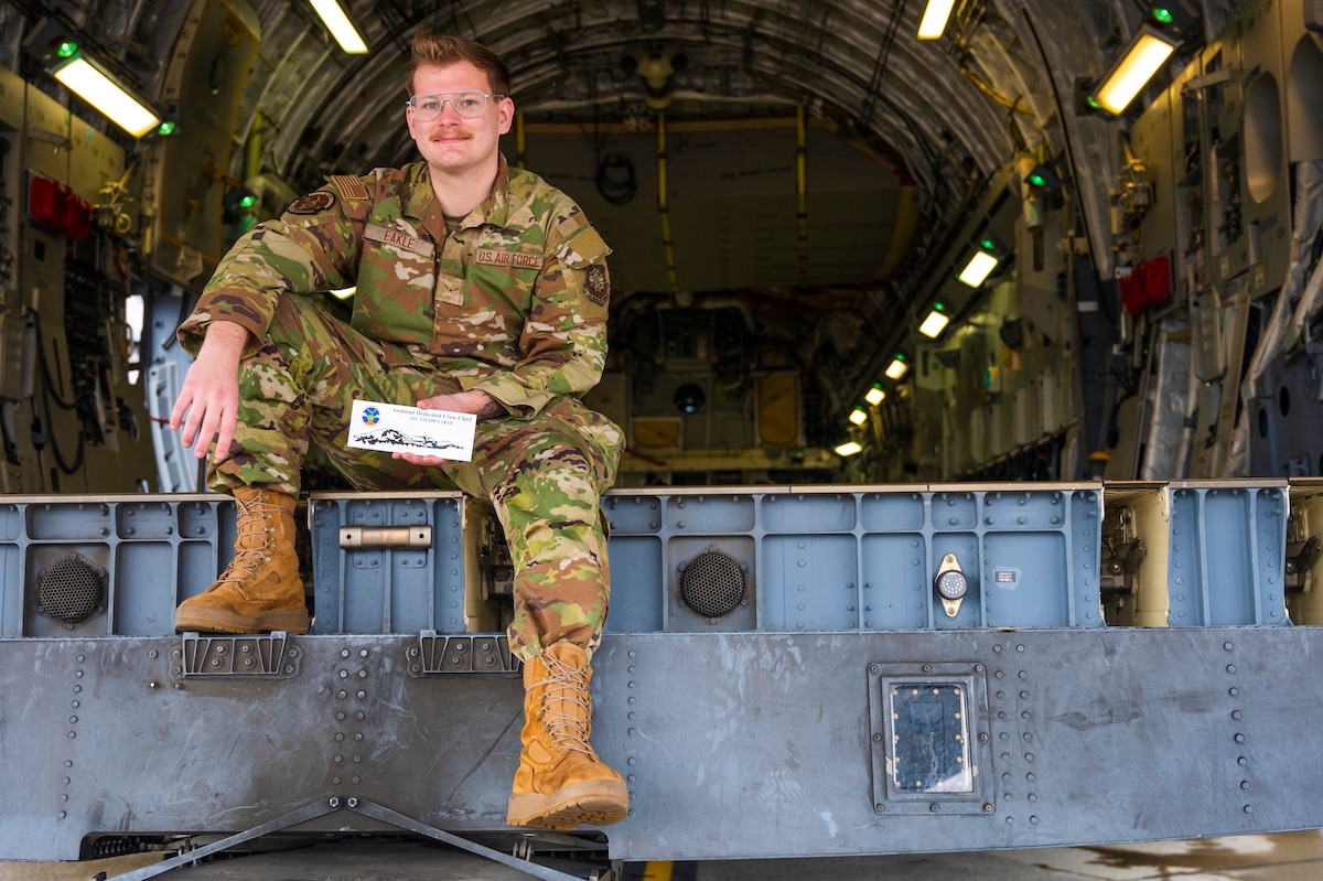 U.S. Air Force Airman First Class Jacob Eakle, 62d Aircraft Maintenance Squadron assistant dedicated crew chief, holds his ADCC plaque aboard the C-17 Globemaster III, tail 0219, he takes ownership of at Joint Base Lewis-McChord, Washington, March 26, 2025.