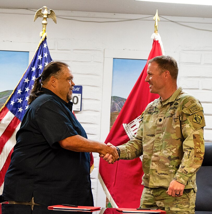 Denny Herrera, left, mayor, Village of Cuba, N.M., and Lt. Col. Matthew Miller, USACE-Albuquerque District commander shake hands after signing a project partnership agreement for a new water storage project at the Village Administrative Office, March 24, 2025.
