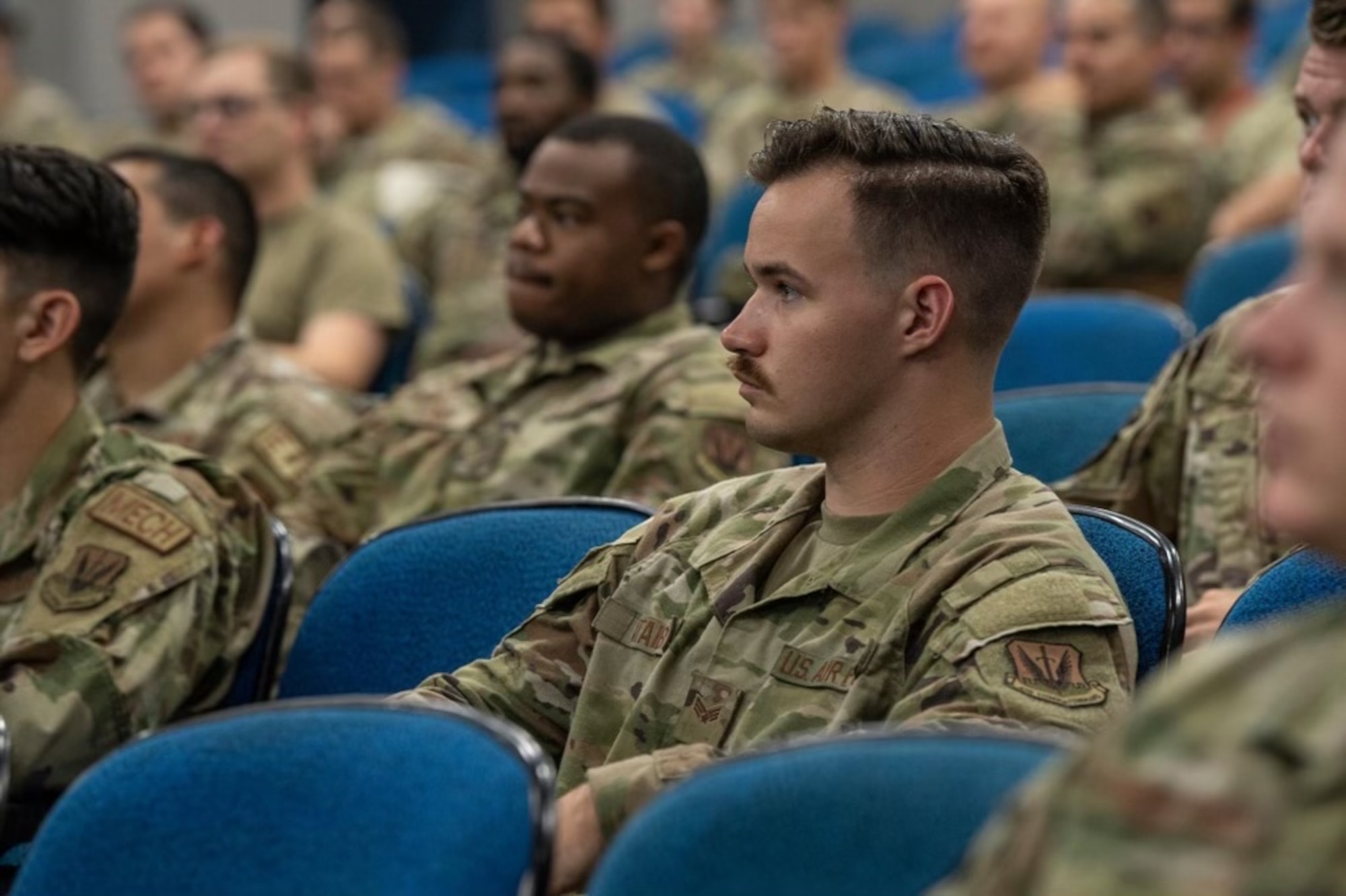 An Airman sits in an all-call.