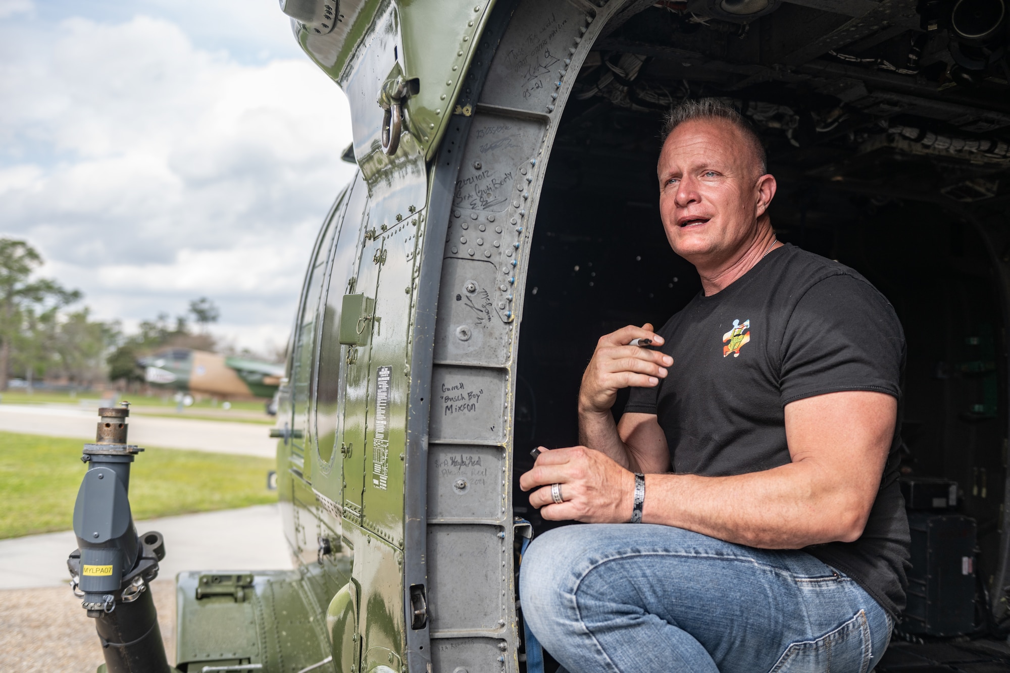 A man is on the inside of the HH-60.
