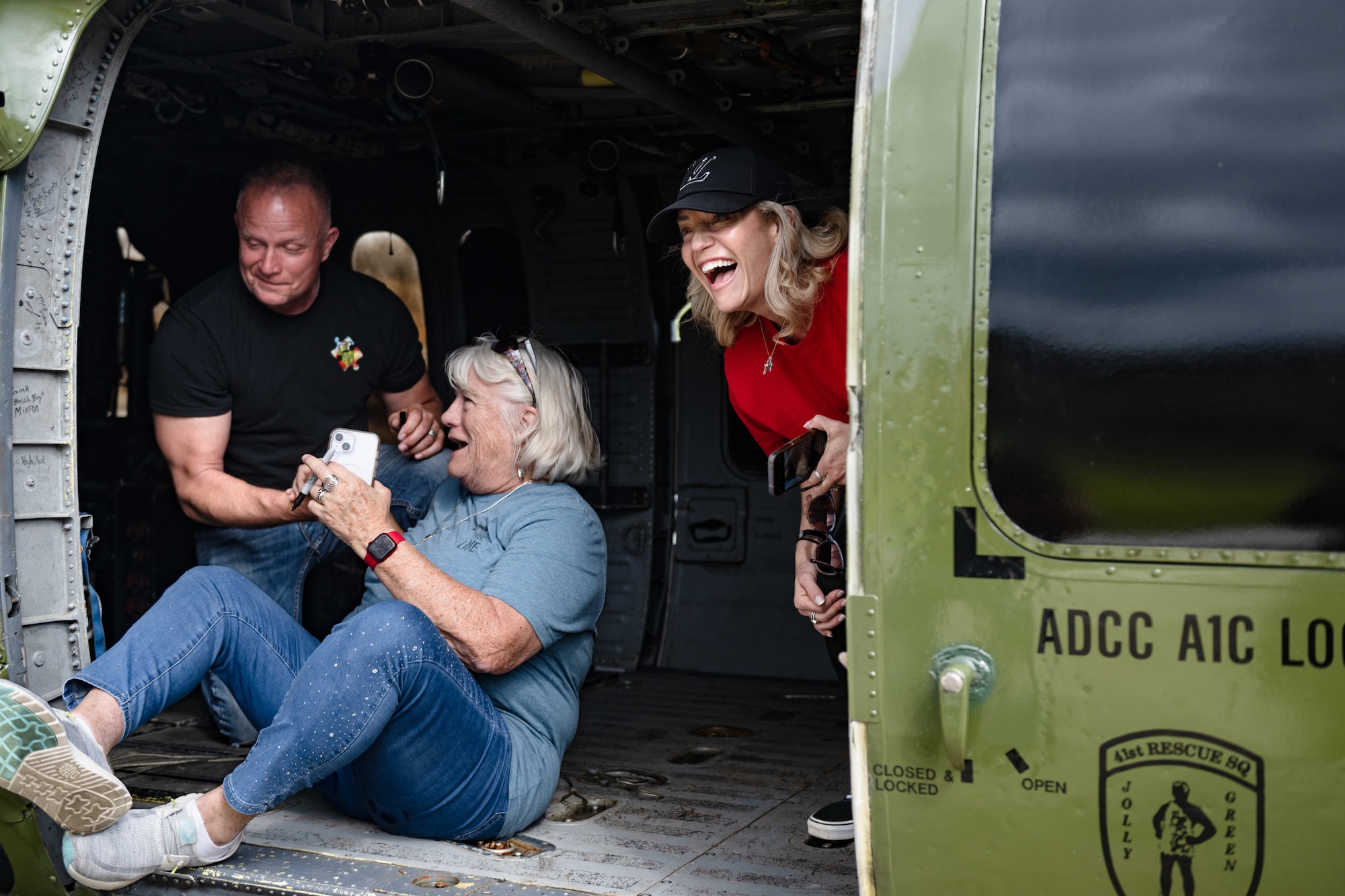 A family writes their names in inside of the HH-60.