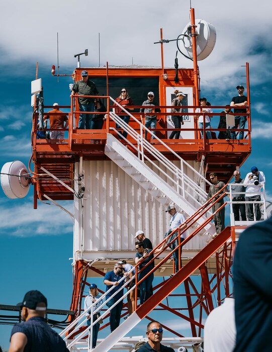 Community leaders observe from an air traffic control tower.
