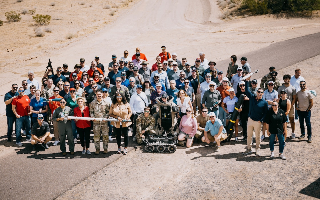 U.S. Air Force Airmen assigned to the 56th Fighter Wing and community leaders stand for a group photo.