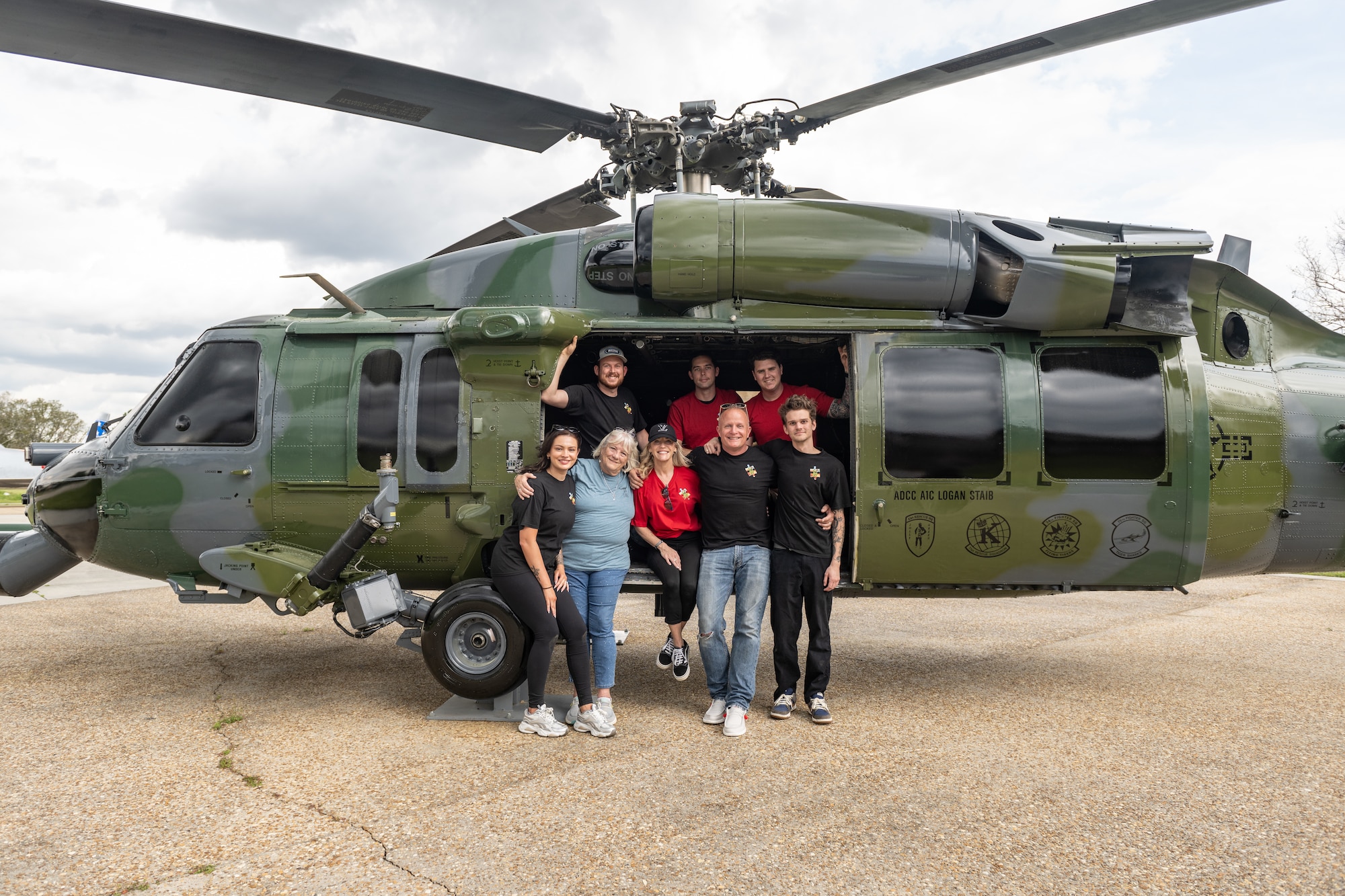 A family stands in front of a HH-60.