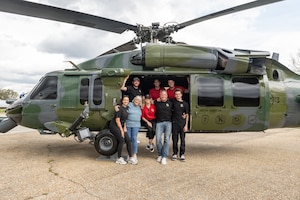 A family stands in front of a HH-60.