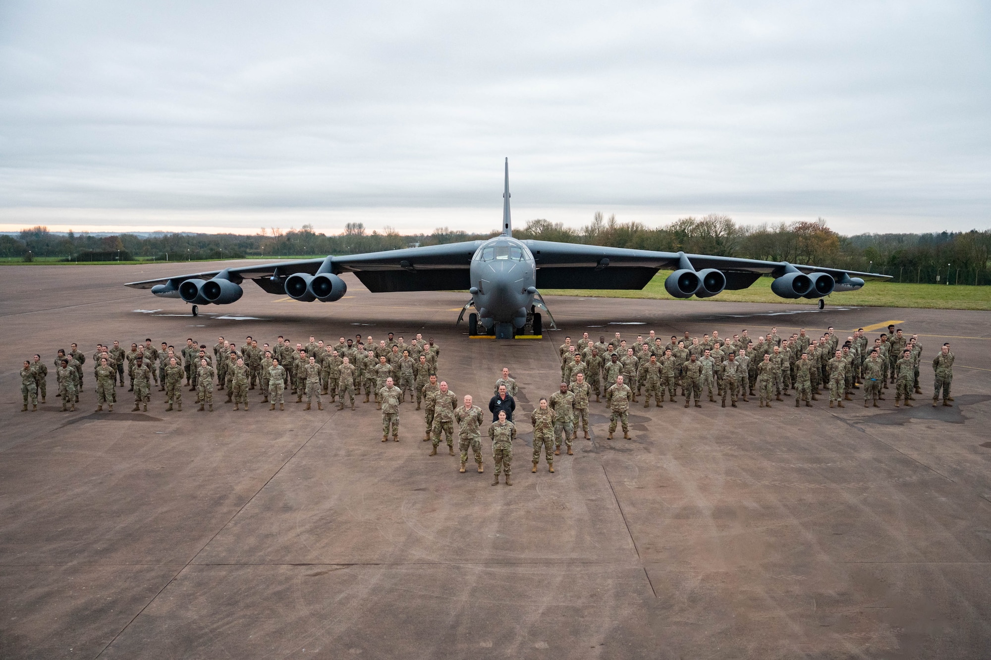 Maintenance Airmen from the 20th Expeditionary Bomb Squadron stand together in front of a B-52H Stratofortress during Bomber Task Force 25-1 Dec. 4, 2024, at RAF Fairford, England.