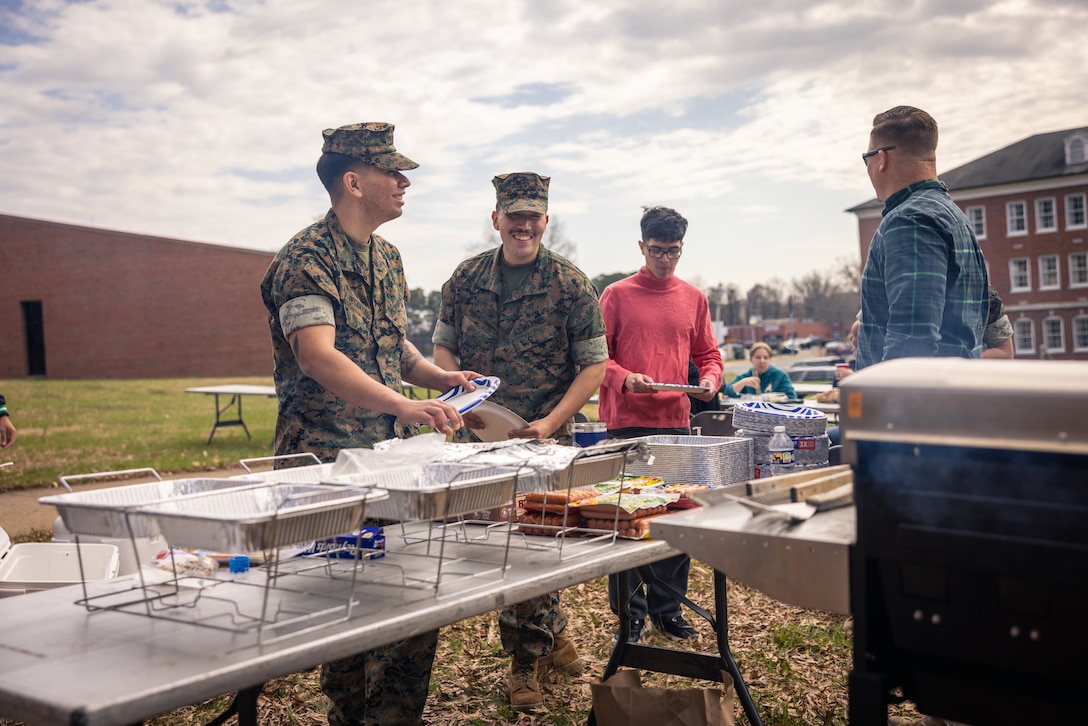 U.S. Marines with Security Battalion get food during a Burger Burn on Marine Corps Base Quantico, Virginia, March 28, 2025. The Burger Burn took place to help build comradery and better the relations amongst the Marines in the battalion. (U.S. Marine Corps photo by Cpl. Joaquin Dela Torre)