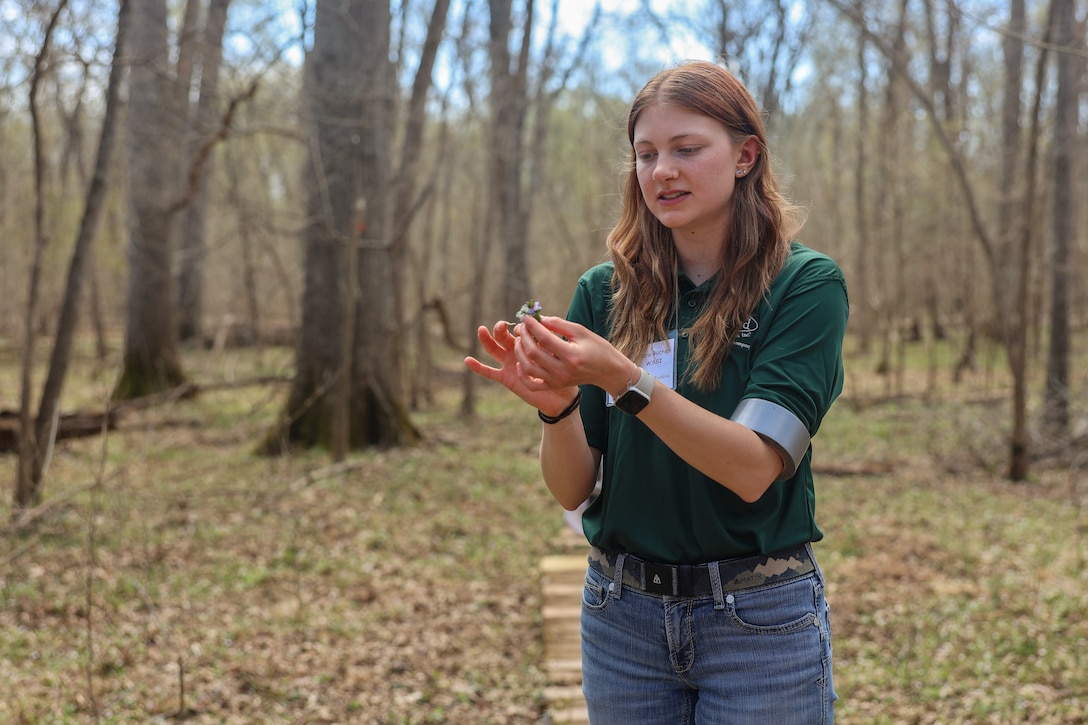 Clara Buchen, a volunteer with Wetland Studies and Solutions Inc., gives a tour over the native and invasive plants along the Bluebell Trail during the annual Bluebell Festival at Merrimac Farm, Nokesville, Virginia, March 30, 2025. The Bluebell Festival began in 2008 after MCB Quantico partnered with Prince William Conservation Alliance, the Virginia Department of Game and Inland Fisheries, and the Virginia Department of Conservation and Recreation to preserve the land and habitat for conservation purposes. The farm has over 300 acres of wetlands and vernal pools, which is one of the most threatened habitats in the United States and creates the perfect area for thousands of bluebell flowers to grow and flourish. (U.S. Marine Corps photo by Sgt. Miranda C. DeKorte)