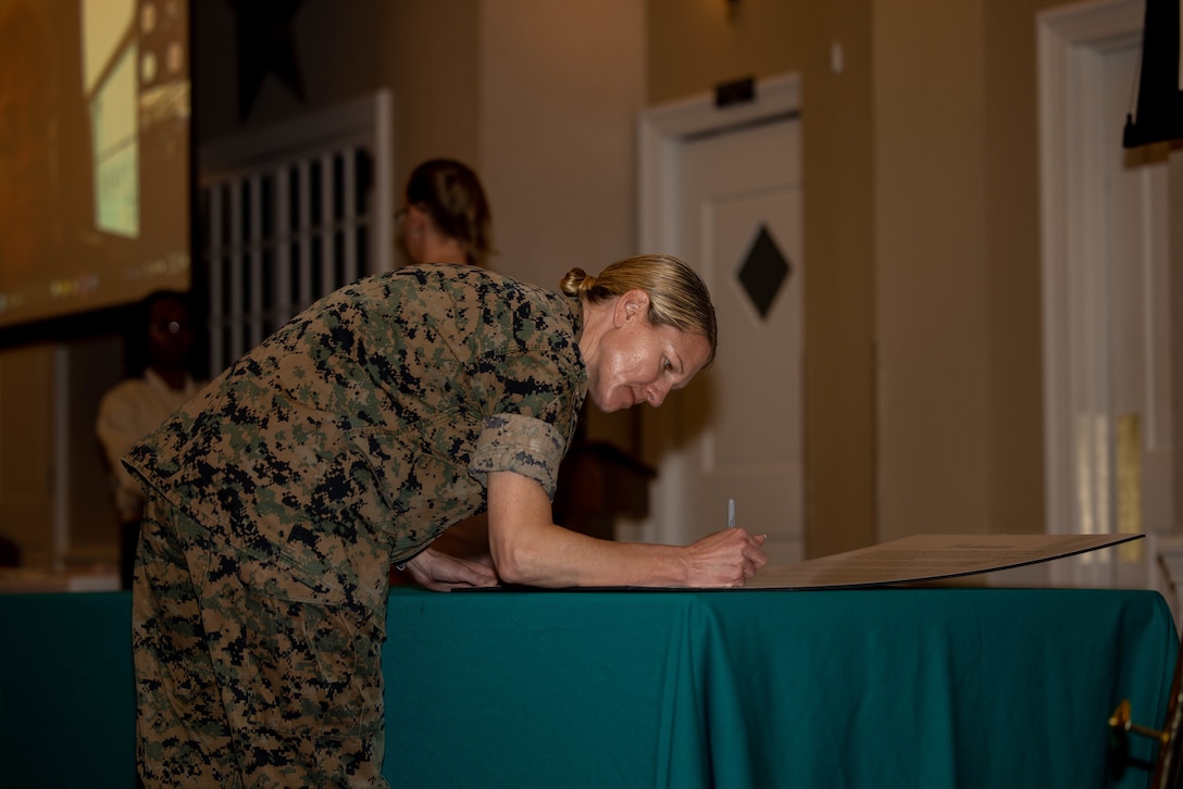 U.S. Marine Corps Col. Jenny Colegate, the base commander for Marine Corps Base Quantico, signs the 2025 Sexual Assault Awareness and Prevention Month proclamation during a proclamation ceremony at MCBQ, Virginia, March 31, 2025. Base leadership and Sexual Assault Prevention and Response personnel signed the 2025 SAAPM proclamation, ‘STEP FOWARD’, encouraging everyone to harness their individual and collective power to drive meaningful change in preventing and addressing sexual violence. (U.S. Marine Corps photo by Lance Cpl. Federico Marquez)