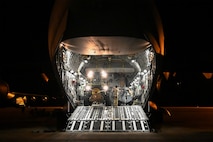 A photo of a jet with the cargo door open.
