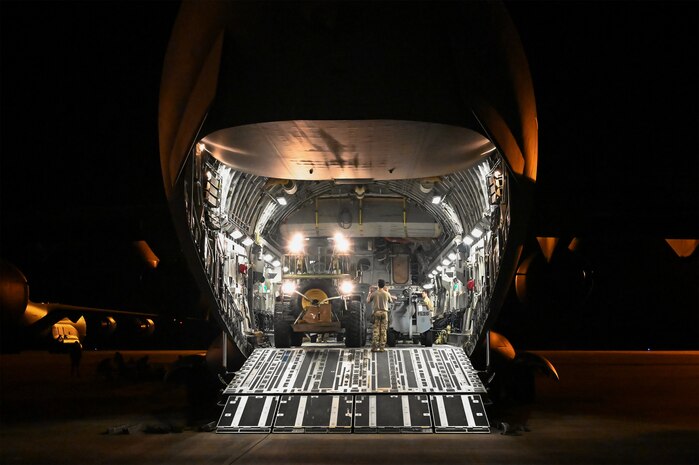 A photo of a jet with the cargo door open.