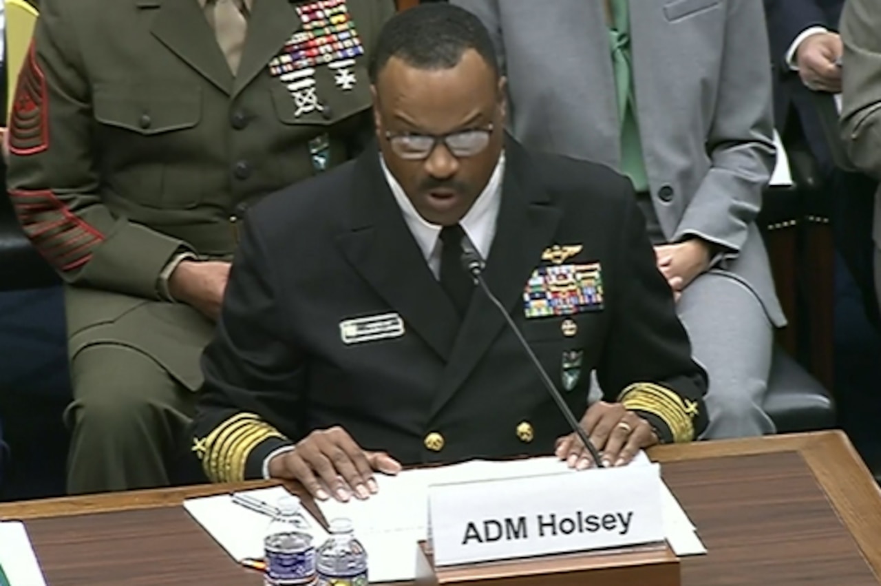 A man speaks into a microphone.