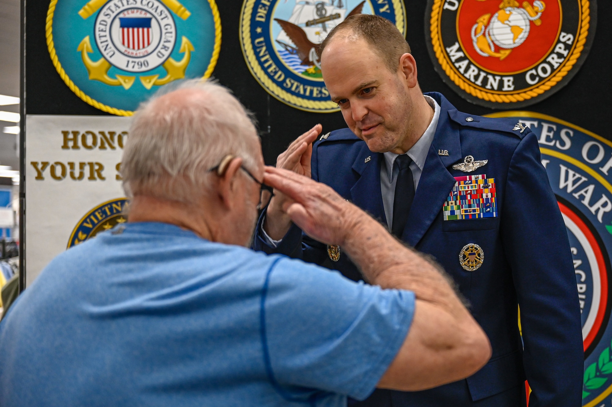 Vietnam War veteran salutes U.S. Air Force Col. Denny Davies, 19th Airlift Wing and installation commander, after receiving a commemorative lapel pin during a ceremony at Little Rock Air Force Base, Arkansas, March 29, 2025. During the ceremony, installation leadership honored the service of Vietnam War veterans and presented them each with a commemorative lapel pin signifying their gratitude.