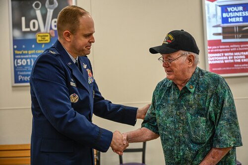 U.S. Air Force Col. Denny Davies, 19th Airlift Wing and installation commander, greets Russell Gillum, Vietnam War veteran, during a pinning ceremony at Little Rock Air Force Base, Arkansas, March 29, 2025. Gillum retired after two decades of service, including time in Vietnam in 1967 and 1968.