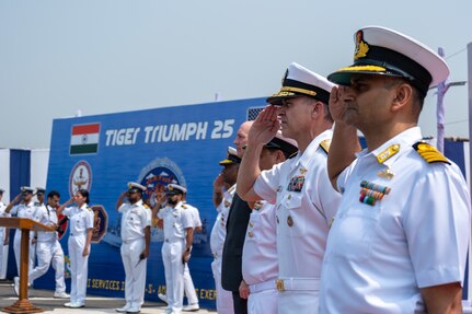 VISAKHAPATNAM, Andhra Pradesh, India (April 1, 2025) - Indian Navy (IN) Rear Adm. Susheel Menon, Flag Officer Commanding Eastern Fleet (FOCEF), front, Rear Adm. Greg Newkirk, Commander, Task Force (CTF) 70, second from right, and other leaders representing U.S. and India joint forces salute during the national anthem on the flight deck aboard the IN amphibious transport dock INS Jalashwa (L41) during the opening ceremony of Exercise Tiger Triumph 2025, at the Naval Dockyard, Visakhapatnam, Andhra Pradesh, India, April 1. Tiger Triumph is a joint and combined U.S.-India exercise focused on humanitarian assistance and disaster relief readiness and interoperability. Tiger Triumph enables U.S. and Indian armed forces to improve interoperability and bilateral, joint, and service readiness in the Indian Ocean region and beyond to support a free and open Indo-Pacific. (U.S. Navy photo by Mass Communication Specialist 1st Class Caroline H. Lui)