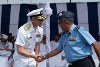 VISAKHAPATNAM, Andhra Pradesh, India (April 1, 2025) - Rear Adm. Greg Newkirk, Commander, Task Force (CTF) 70, shakes hands with Indian Air Force Lt. Gen. Sandeep Thareja, Director General Medical Services (Air), on the flight deck aboard the Indian Navy amphibious transport dock INS Jalashwa (L41) during the opening ceremony of Exercise Tiger Triumph 2025, at the Naval Dockyard, Visakhapatnam, Andhra Pradesh, India, April 1. Tiger Triumph is a joint and combined U.S.-India exercise focused on humanitarian assistance and disaster relief readiness and interoperability. Tiger Triumph enables U.S. and Indian armed forces to improve interoperability and bilateral, joint, and service readiness in the Indian Ocean region and beyond to support a free and open Indo-Pacific. (U.S. Navy photo by Mass Communication Specialist 1st Class Caroline H. Lui)