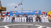 VISAKHAPATNAM, Andhra Pradesh, India (April 1, 2025) - Leaders representing U.S. and India joint forces pose for a group photo on the flight deck aboard the Indian Navy amphibious transport dock INS Jalashwa (L41) during the opening ceremony of Exercise Tiger Triumph 2025, at the Naval Dockyard, Visakhapatnam, Andhra Pradesh, India, April 1. Tiger Triumph is a joint and combined U.S.-India exercise focused on humanitarian assistance and disaster relief readiness and interoperability. Tiger Triumph enables U.S. and Indian armed forces to improve interoperability and bilateral, joint, and service readiness in the Indian Ocean region and beyond to support a free and open Indo-Pacific. (U.S. Navy photo by Mass Communication Specialist 1st Class Caroline H. Lui)