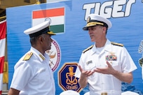 VISAKHAPATNAM, Andhra Pradesh, India (April 1, 2025) - Rear Adm. Greg Newkirk, Commander, Task Force (CTF) 70, speaks with Indian Navy (IN) Rear Adm. Susheel Menon, Flag Officer Commanding Eastern Fleet (FOCEF), on the flight deck aboard the IN amphibious transport dock INS Jalashwa (L41) during the opening ceremony of Exercise Tiger Triumph 2025, at the Naval Dockyard, Visakhapatnam, Andhra Pradesh, India, April 1. Tiger Triumph is a joint and combined U.S.-India exercise focused on humanitarian assistance and disaster relief readiness and interoperability. Tiger Triumph enables U.S. and Indian armed forces to improve interoperability and bilateral, joint, and service readiness in the Indian Ocean region and beyond to support a free and open Indo-Pacific. (U.S. Navy photo by Mass Communication Specialist 1st Class Caroline H. Lui)