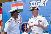 VISAKHAPATNAM, Andhra Pradesh, India (April 1, 2025) - Rear Adm. Greg Newkirk, Commander, Task Force (CTF) 70, speaks with Indian Navy (IN) Rear Adm. Susheel Menon, Flag Officer Commanding Eastern Fleet (FOCEF), on the flight deck aboard the IN amphibious transport dock INS Jalashwa (L41) during the opening ceremony of Exercise Tiger Triumph 2025, at the Naval Dockyard, Visakhapatnam, Andhra Pradesh, India, April 1. Tiger Triumph is a joint and combined U.S.-India exercise focused on humanitarian assistance and disaster relief readiness and interoperability. Tiger Triumph enables U.S. and Indian armed forces to improve interoperability and bilateral, joint, and service readiness in the Indian Ocean region and beyond to support a free and open Indo-Pacific. (U.S. Navy photo by Mass Communication Specialist 1st Class Caroline H. Lui)