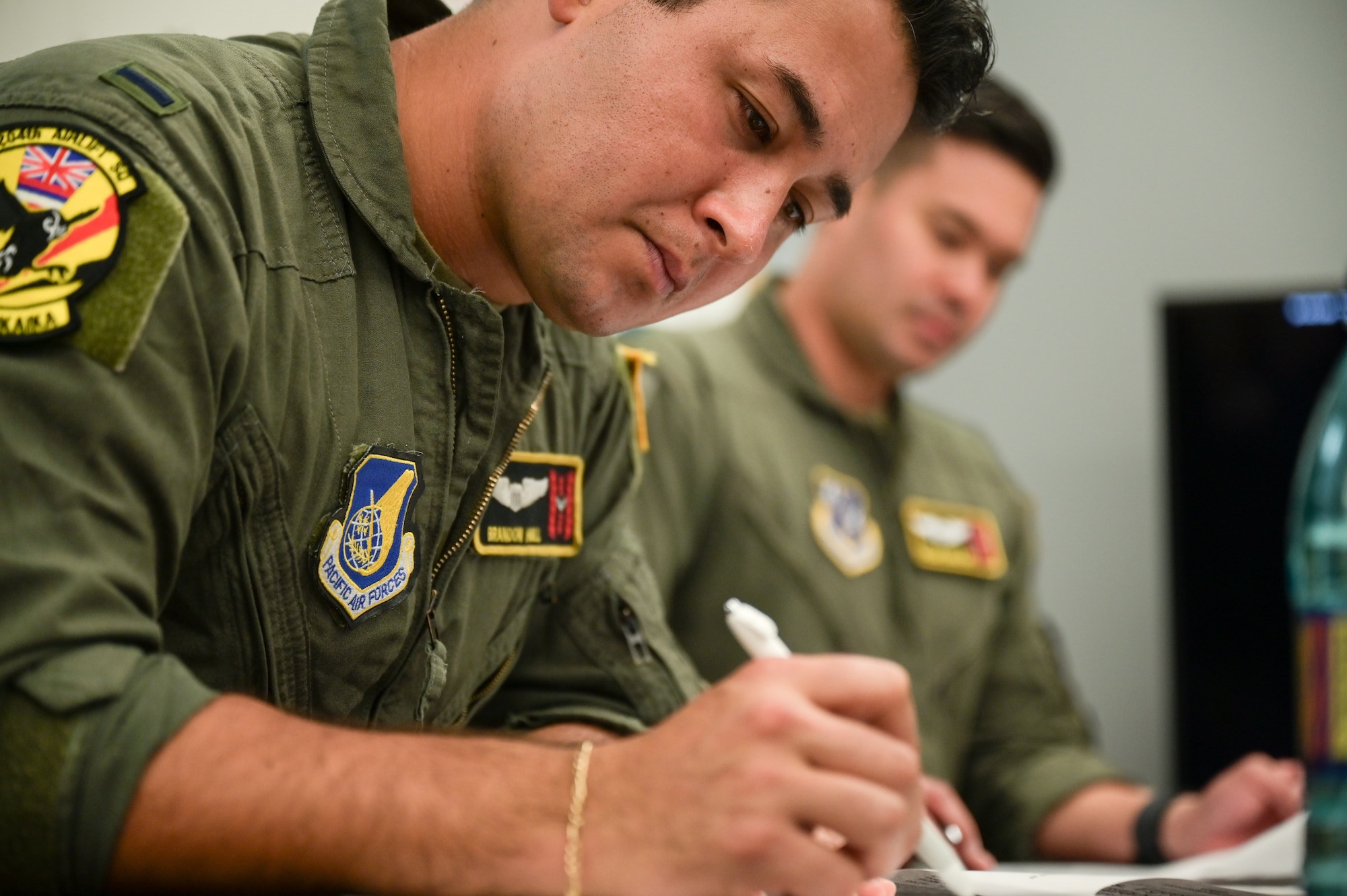 Airman uses a pen.