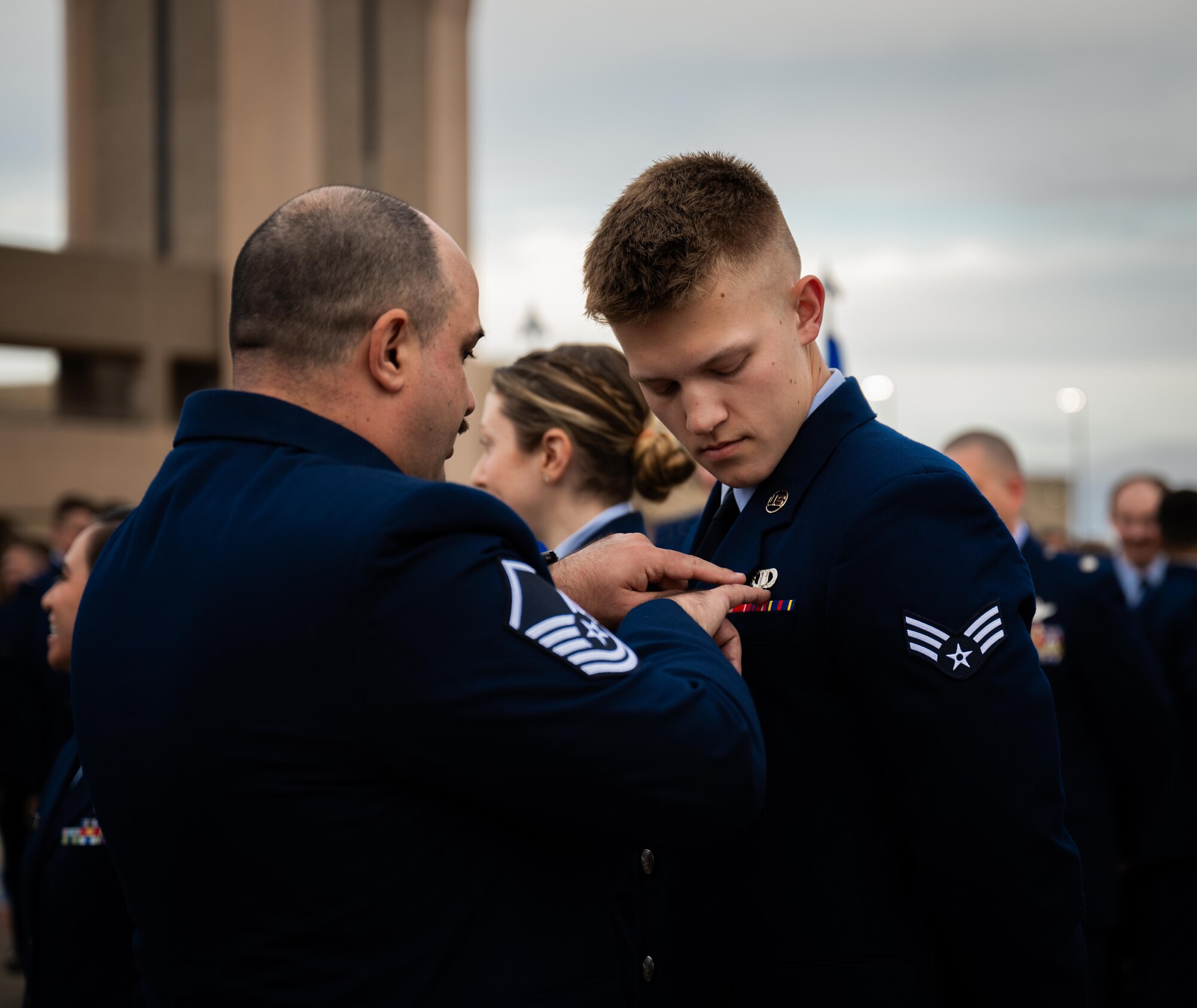 U.S. Air Force Master Sgt. inspects an Airmen’s blues at Laughlin Air Force Base on March 28, 2025. 1,200 total force Airmen lined up on the flightline for their standards and readiness review blues inspection. (U.S. Air Force photo by Airman 1st Class Harrison Sullivan)