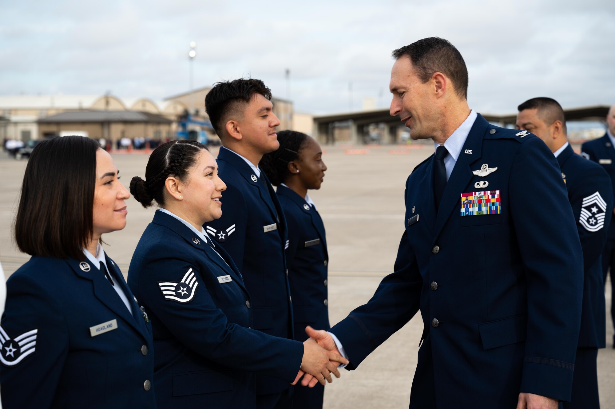 U.S. Air Force Col. Tyler Ellison, 47th Flying Training Wing, Commander, shakes hands with U.S. Air Force Staff Sgt. Jennifer Velasco, 47th Flying Training Wing, financial management technician at Laughlin Air Force Base on March 28, 2025. 1,200 total force Airmen lined up on the flightline for their standards and readiness review blues inspection. (U.S. Air Force photo by Airman 1st Class Harrison Sullivan)