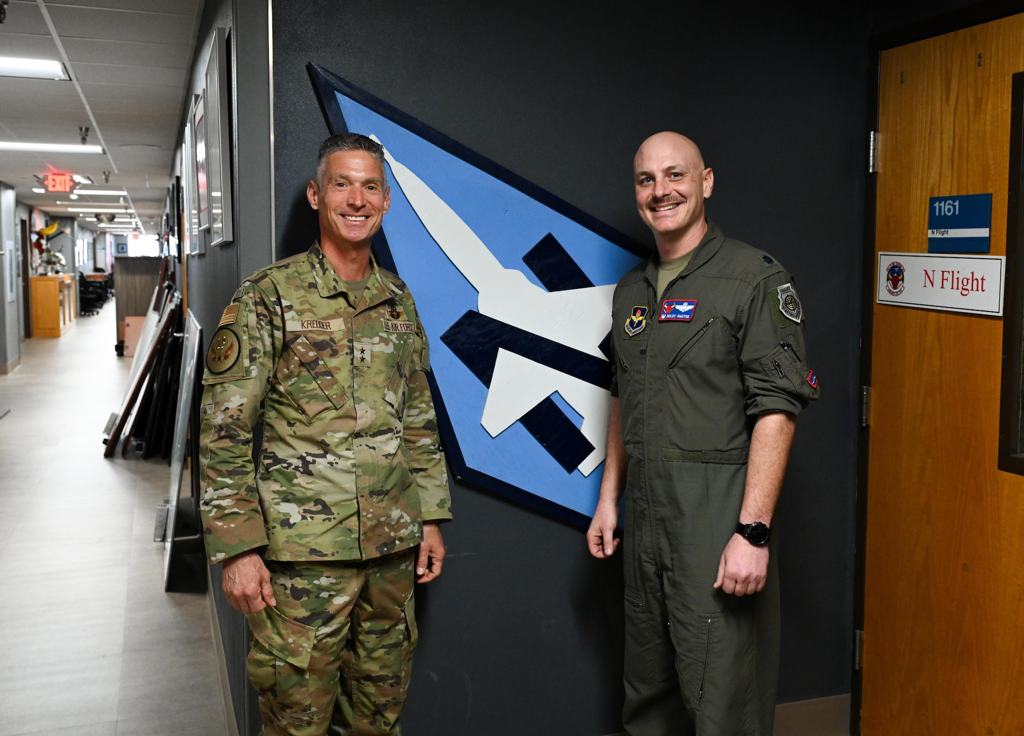 U.S. Air Force Maj. Gen. Gregory Kreuder, 19th Air Force, commander and U.S. Air Force Lt. Col. Johnathan Radtke, 87th Flying Training Squadron, commander, takes a photo in front of the Nachos flight at Anderson Hall, March 13, 2025. Kreuder was part of Nachos flight when going though pilot training back at Laughlin Air Force Base in 1995 - 1996. (U.S. Air Force Photo by Airman 1st Class Harrison Sullivan)