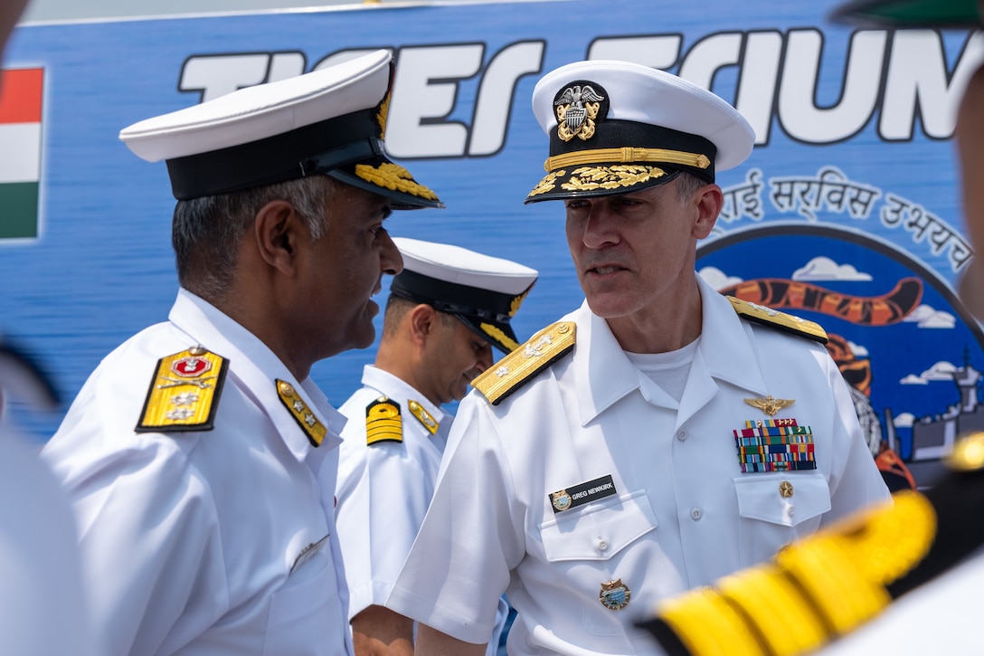 VISAKHAPATNAM, Andhra Pradesh, India (April 1, 2025) - Rear Adm. Greg Newkirk, Commander, Task Force (CTF) 70, speaks with Indian Navy (IN) Rear Adm. Susheel Menon, Flag Officer Commanding Eastern Fleet (FOCEF), on the flight deck aboard the IN amphibious transport dock INS Jalashwa (L41) during the opening ceremony of Exercise Tiger Triumph 2025, at the Naval Dockyard, Visakhapatnam, Andhra Pradesh, India, April 1. Tiger Triumph is a joint and combined U.S.-India exercise focused on humanitarian assistance and disaster relief readiness and interoperability. Tiger Triumph enables U.S. and Indian armed forces to improve interoperability and bilateral, joint, and service readiness in the Indian Ocean region and beyond to support a free and open Indo-Pacific. (U.S. Navy photo by Mass Communication Specialist 1st Class Caroline H. Lui)