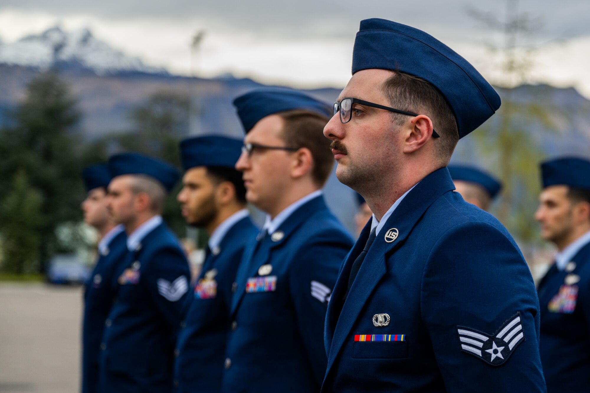 U.S. Air Force Senior Airman Johnathan Holiday, 31st Operations Support Squadron aircrew flight equipment journeyman, and other Airmen from the 31st OSS stand at parade rest during retreat.