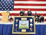 Retired Col. John Mollison, from left, 95th Bomb Group Memorials Foundation membership chair, presents a heritage gift to Maj. Gen. Jason Armagost, commander of 8th Air Force and Joint-Global Strike Operations Center and Col. David Leaumont, 95th Wing commander, on behalf of the 95th Bomb Group Memorials Foundation during the 95th Wing activation ceremony, March 28, 2025, at Offutt Air Force Base, Nebraska. The 95th Wing traces its lineage to