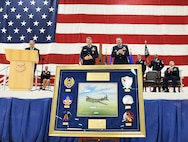 Retired Col. John Mollison, from left, 95th Bomb Group Memorials Foundation membership chair, presents a heritage gift to Maj. Gen. Jason Armagost, commander of 8th Air Force and Joint-Global Strike Operations Center and Col. David Leaumont, 95th Wing commander, on behalf of the 95th Bomb Group Memorials Foundation during the 95th Wing activation ceremony, March 28, 2025, at Offutt Air Force Base, Nebraska. The 95th Wing traces its lineage to