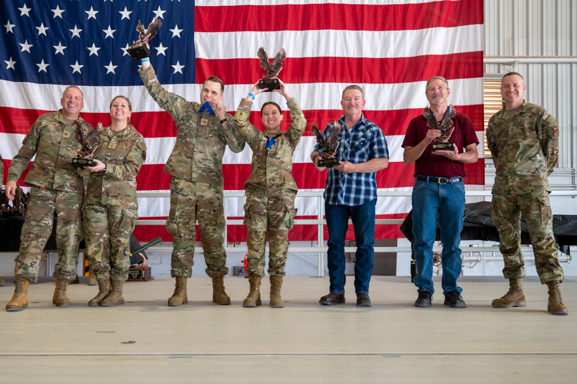U.S. Air Force Airmen of the 49th Maintenance Group accept the Maintenance Operations Support Professional Award from U.S. Air Force Col. Chris Dunston, 49th Maintenance Group commander, left, and U.S. Air Force Chief Master Sgt. Andrew Stokes, 49th MXG superintendent, right, at Holloman Air Force Base, New Mexico, March 28, 2025. The Maintenance Operations Support Professional Award recognizes maintenance professionals who have set the standards for technical expertise, resource management and leadership. (U.S. Air Force photo by Senior Airman Michelle Ferrari)