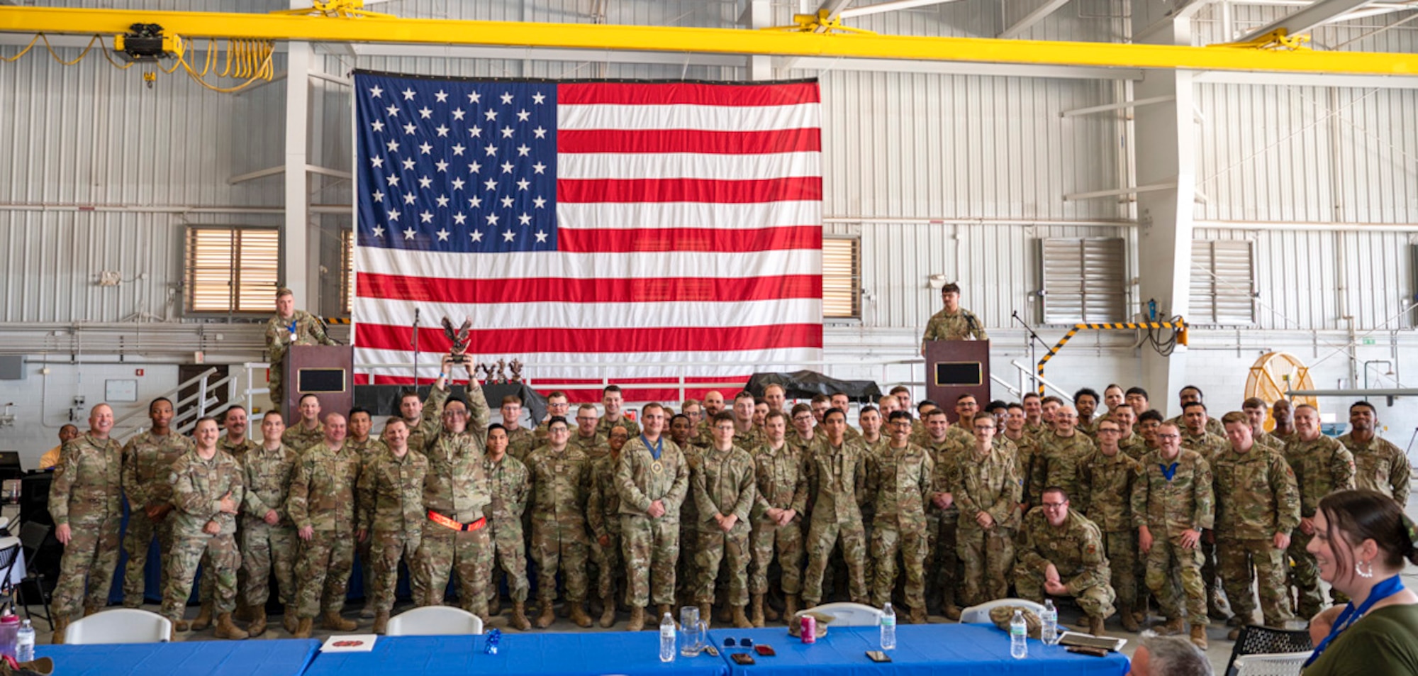 U.S. Air Force Airmen of the 29th Aircraft Maintenance Unit accept the Aircraft Maintenance Unit of the Year Award from U.S. Air Force Col. Chris Dunston, 49th Maintenance Group commander and U.S. Air Force Chief Master Sgt. Andrew Stokes, 49th MXG superintendent, at Holloman Air Force Base, New Mexico, March 28, 2025. The Aircraft Maintenance Unit of the Year Award recognizes an aircraft maintenance unit for sustained performance and contributions to sortie generation. (U.S. Air Force photo by Senior Airman Michelle Ferrari)