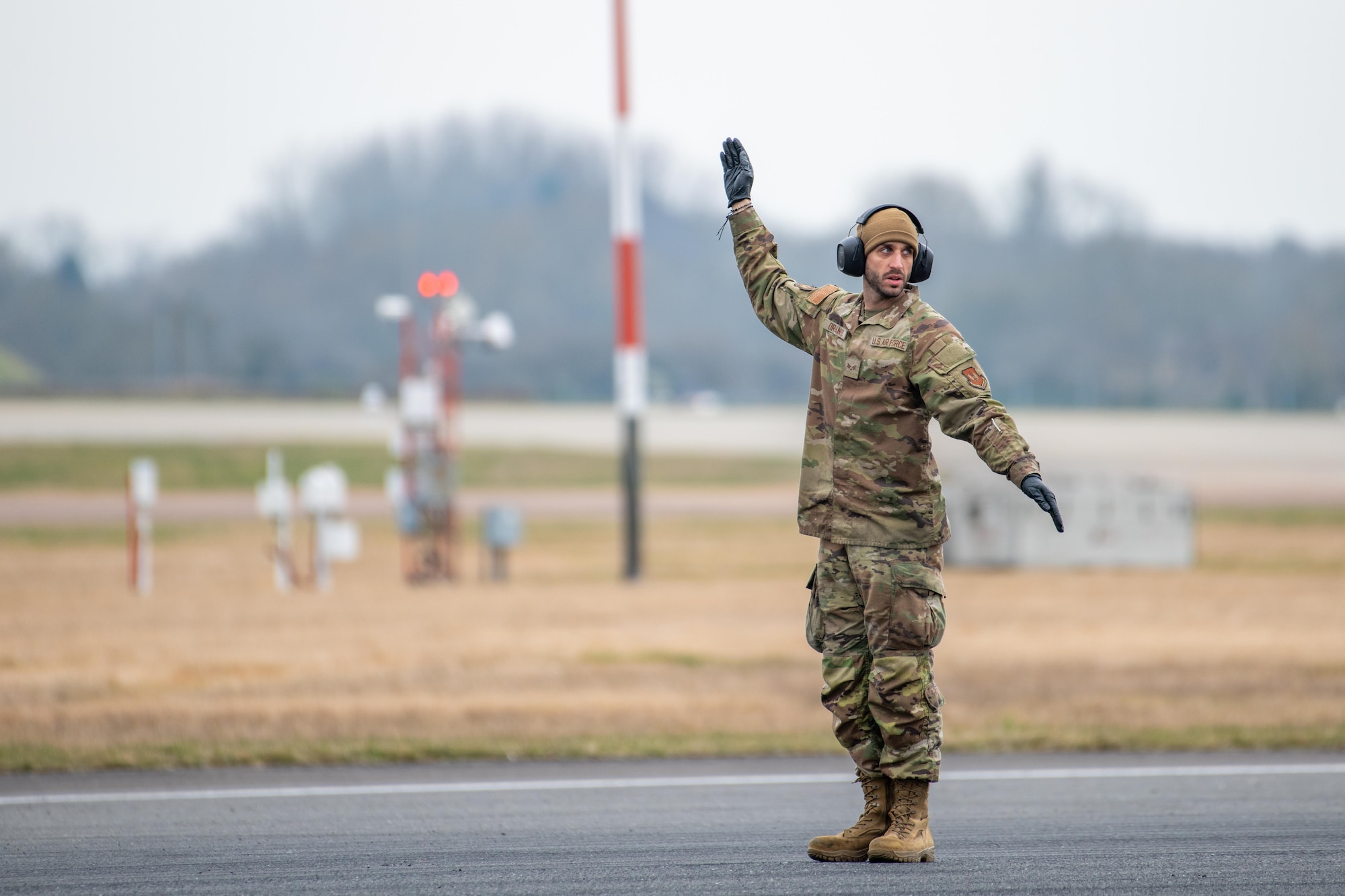 An Airman guides rewind operations to reset a Mobile Aircraft Arresting System