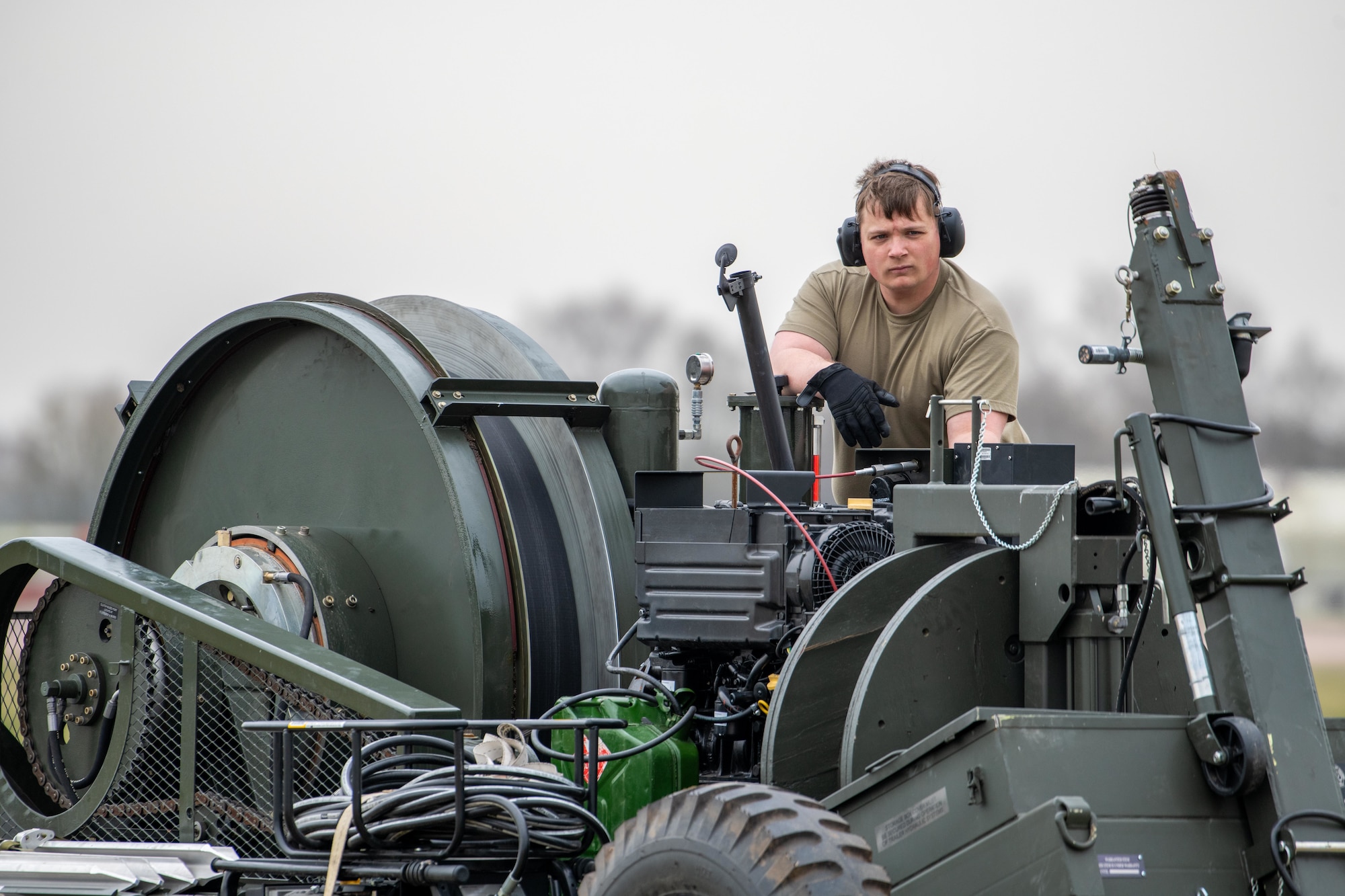 An Airman performs rewind operations on a Mobile Aircraft Arresting System