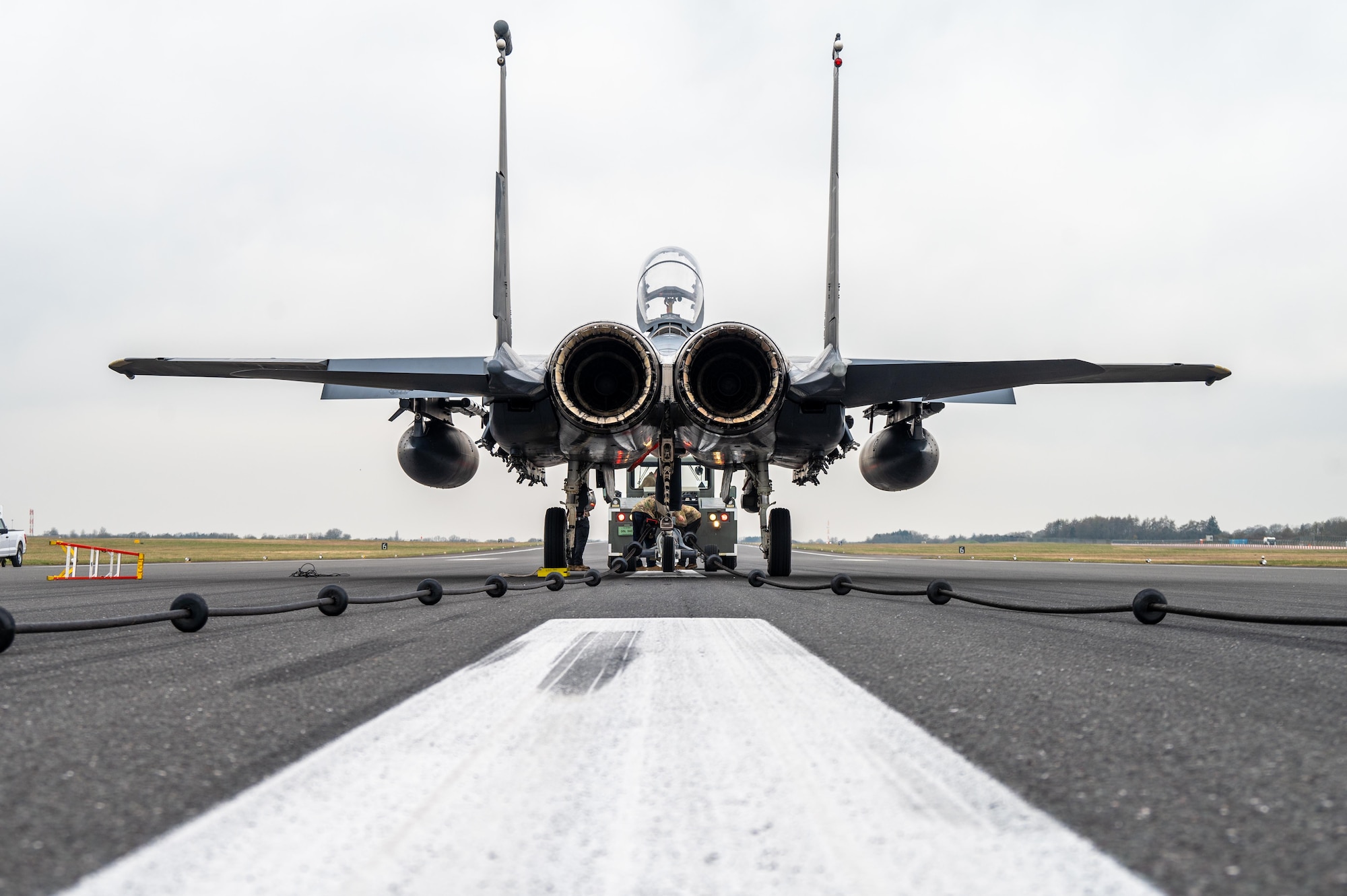 A F-15E Strike Eagle sits on a runway after testing a Mobile Aircraft Arresting System