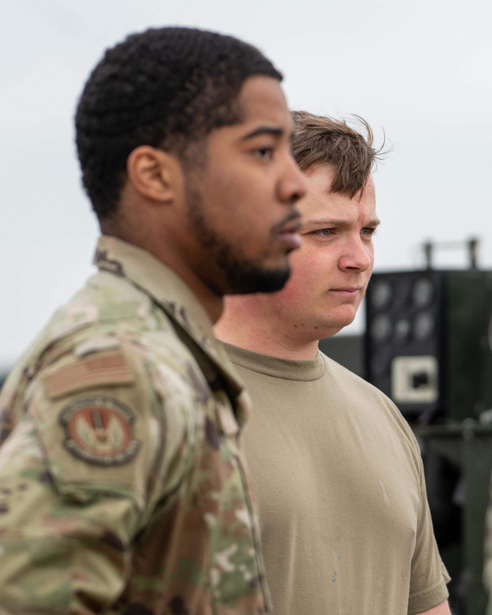 Airmen watch as A F-15E Strike Eagle prepares to test a Mobile Aircraft Arresting System