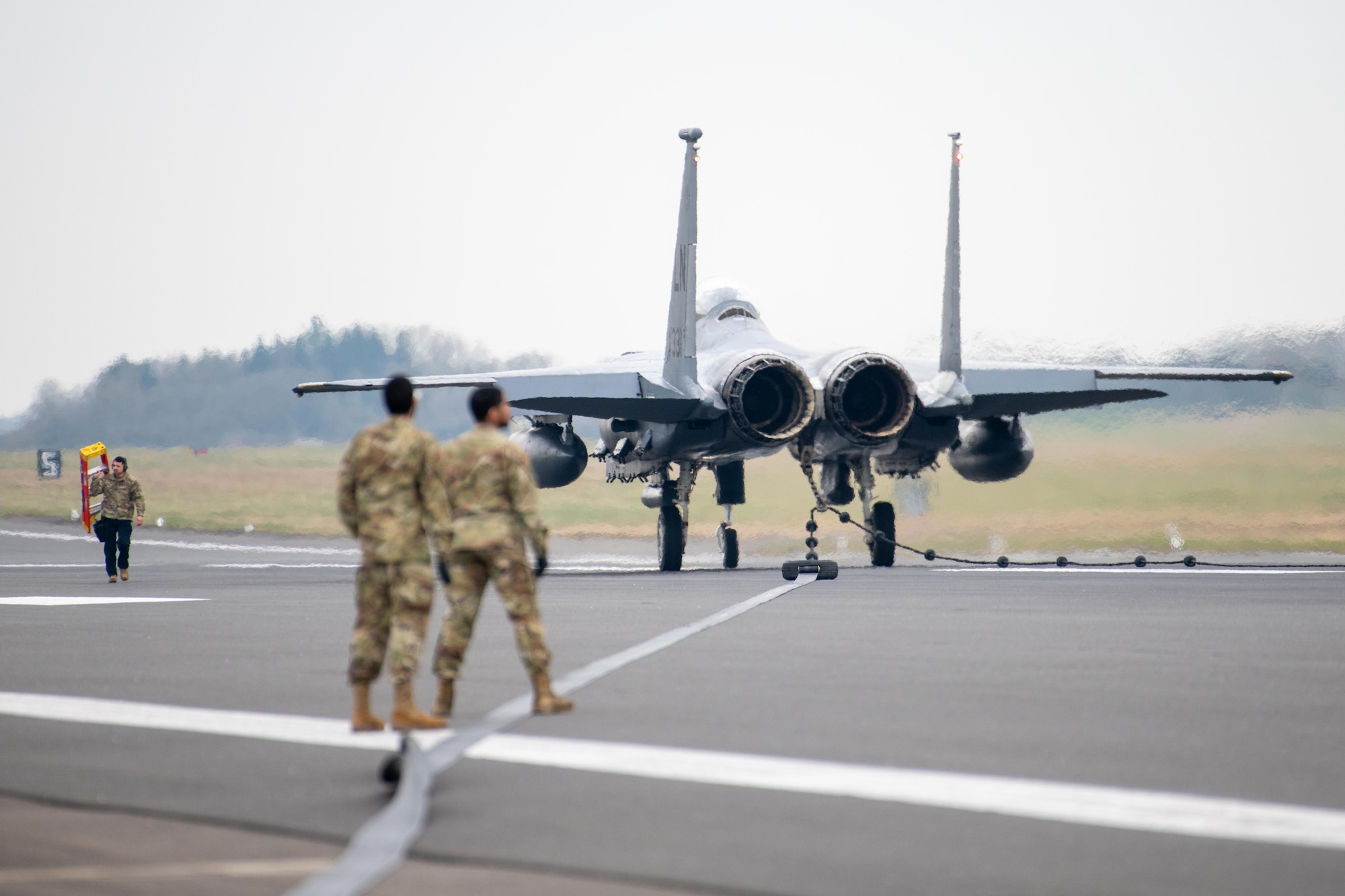 A F-15E Strike Eagle sits on a runway after testing a Mobile Aircraft Arresting System