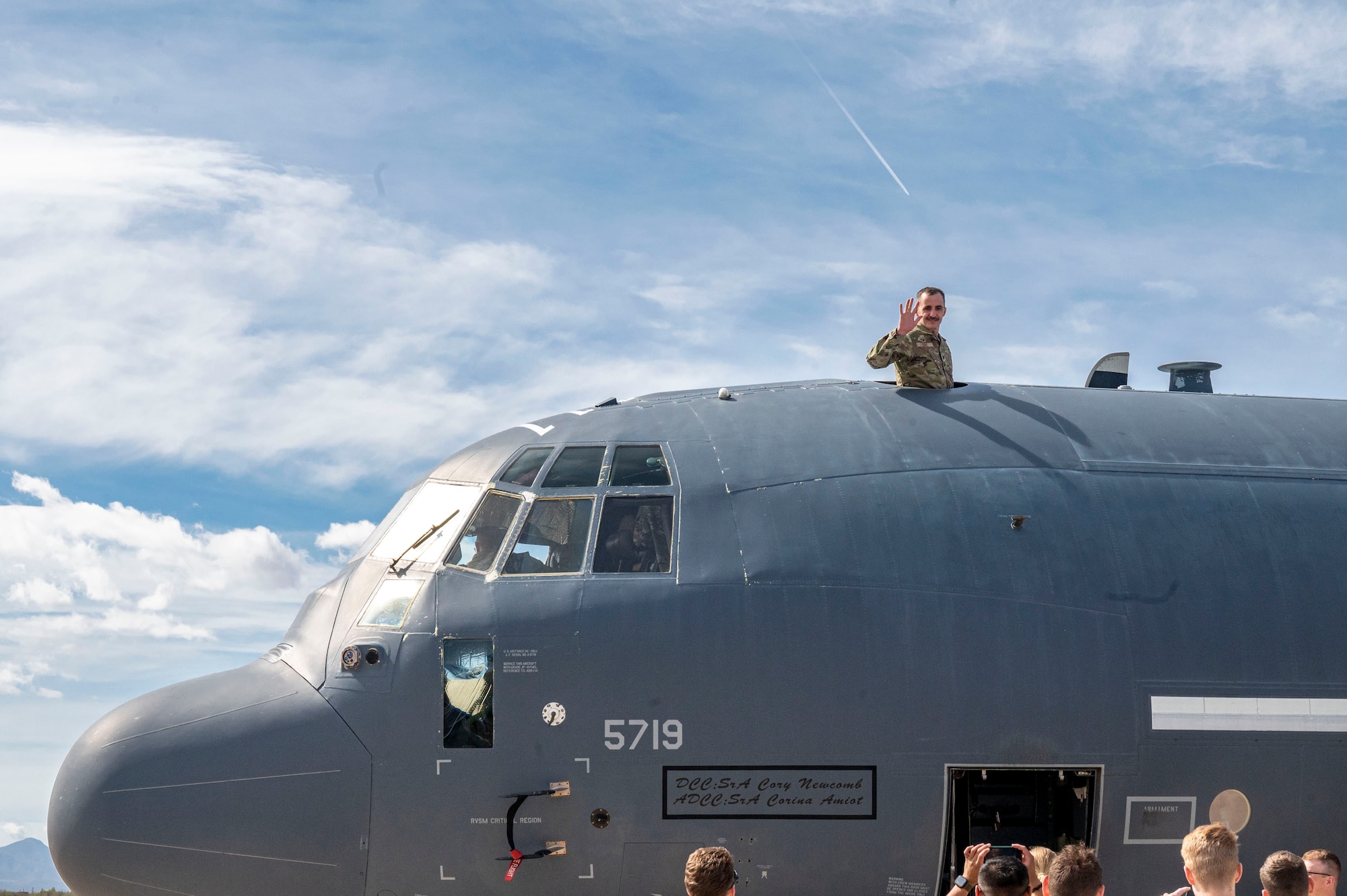 U.S. Air Force Lt. Col. Bret Cove, Reserve Officers Training Course Detachment 409 commander, waves from the top of an HC-130J Combat King II aircraft during a tour at Davis-Monthan Air Force Base, Arizona, April 1, 2025. The AFROTC program trains and develops future officers by instilling leadership skills, promoting discipline and aligning with the Air Force's core values and mission priorities. (U.S. Air Force photo by Airman Samantha Melecio)