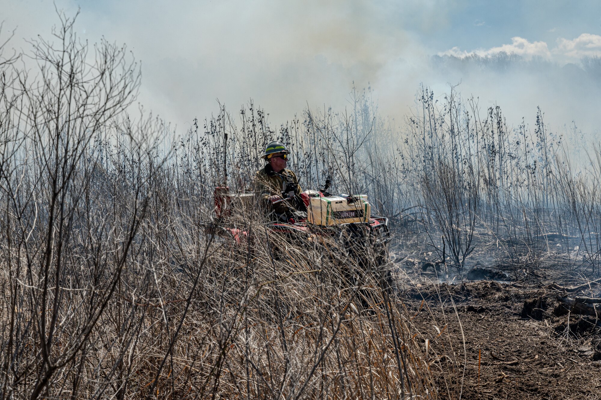 Firefighter sits on ATV